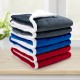 Stack of reversible electric heated blankets in blue, red, and gray flannel and sherpa, ideal for warmth and comfort.
