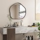 Irregular black wall mirror with metal frame, showcasing a clear reflection, ideal for indoor decor and easy.