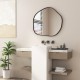Irregular black wall mirror with metal frame, showcasing rounded edges and clear reflection, ideal for indoor decor.