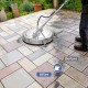 Pressure washer surface cleaner attachment with 20-inch stainless steel housing, shown in action on patio tiles.