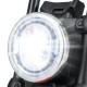 Close-up of the bright LED headlight on a red kids electric motorcycle with training wheels for safe riding.
