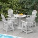White HDPE patio chairs with armrests and footrests around a round table, perfect for outdoor relaxation by the pool.