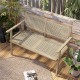 Teak wood garden bench with natural rattan backrest, designed for two, perfect for patio or garden relaxation.