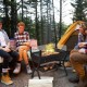 Barbecue charcoal grill with wind guard, featuring a 280 sq.in. cooking area, used for camping and outdoor cooking.