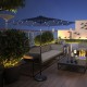 Dark blue 9-foot solar LED lighted patio umbrella with tilt adjustment, perfect for outdoor relaxation and shade.