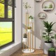 Three-tier indoor metal plant stand with golden frame and white shelves, designed for stylish corner plant arrangement.
