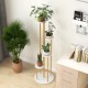 Indoor metal plant stand featuring a golden frame and white shelves, showcasing potted plants in a compact design.