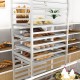 20-tier bun pan speed rack with lockable rubber wheels, showcasing various baked goods for bakery or restaurant use.