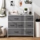 Close-up view of gray fabric drawer with metal handle, part of a white fabric dresser for organized bedroom storage.