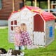 Cottage kids playhouse with red roof, blue windows, and openable door, perfect for imaginative outdoor play.