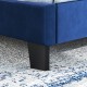Close-up of the blue velvet bed frame leg with nailhead trim, showcasing sturdy support for queen size mattresses.