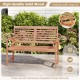 Patio solid wood loveseat with inclined backrest and slatted seat, crafted with teak oil for outdoor comfort and beauty.