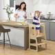 Toddler using the 3-in-1 foldable kitchen standing tower with chalkboard, promoting independence in family activities.