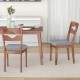 Set of 2 gray fabric upholstered dining chairs with padded seats and natural rubber wood frame for rustic kitchen decor.
