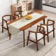 Walnut dining room table with decorative runner and four solid rubber wood chairs featuring wrap-around armrests.