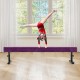 Purple 7.5 feet gymnastics beam with adjustable height, featuring a child practicing a handstand indoors.
