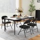 Black folding chairs with metal frame and PVC leather, set at a dining table for indoor or outdoor use.