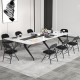 Black folding chairs with metal frame and PVC leather, arranged around a conference table for meetings and events.