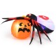 Inflatable spider with pumpkin, featuring LED lights and colorful rotating light, perfect for Halloween backyard.