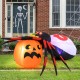 Inflatable spider and pumpkin decoration with colorful rotating light, perfect for Halloween backyard displays.