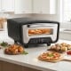 Indoor electric pizza oven with dual heating zones, 850℉ max temperature, and 8 presets for easy cooking of 12-inch pizzas.