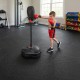 Kid using the inflation-free boxing set with adjustable height and 12-piece puzzle exercise mat for safe training.