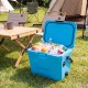 Bright blue insulated portable cooler with drinks inside, featuring cup holders, perfect for camping and outdoor.