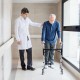 Height adjustable aluminum walker with rolling wheels, designed for stability and ease of use by seniors and.