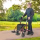 Adjustable red rollator walker with storage bag, shown on a path, providing comfort and stability for outdoor use.