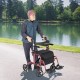 Folding rollator walker in red with seat and wheels, supporting up to 300 lbs, ideal for outdoor mobility.