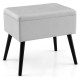 Gray velvet storage ottoman with solid wood legs, featuring a hinged lid for easy access and multifunctional use.