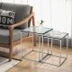 Modern nesting coffee tables with tempered glass tops and steel frames, ideal for stylish and space-saving arrangements.