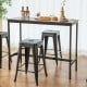 Black 24-inch Tolix style counter height barstools with a stackable design, perfect for kitchen or home bar use.