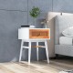 Modern bedside table with solid wood legs, rattan front panel, and large drawer, perfect for bedroom or living room use.