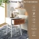 Modern bedside table with solid wood legs and rattan drawer front, ideal for lamps and plants in any room.