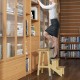 Rubber wood step stool with anti-slip surface, used as a ladder for reaching high shelves, featuring a convenient.