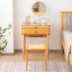 Bamboo makeup vanity table with rotating mirror and stool, featuring two drawers and tempered glass top for organized.