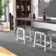 Two 24-inch dining bar stools with sponge padded seats and decorative rivets, perfect for stylish kitchen or dining.