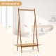 Bamboo clothes rack with hanging rod, rattan shelf, and copper hooks, measuring 65.5" tall, ideal for entryway storage.