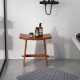 Curved seat shower stool made of solid teak wood, featuring non-slip foot pads, perfect for indoor and outdoor use.