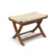 Folding natural rattan ottoman with hand-woven seat, crafted from teak wood for rustic appeal and space-saving.