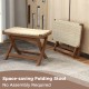 Folding natural rattan ottoman with hand-woven seat, crafted from teak wood, space-saving design for compact areas.