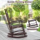 High-back acacia wood outdoor rocking chair in brown with a stable rocking base, perfect for backyard relaxation.