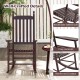 High-back acacia wood outdoor rocking chair with slatted seat and cozy armrests, perfect for backyard relaxation.