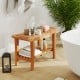 Teak shower stool with storage shelf, featuring a slatted design and non-slip footpads, perfect for bathroom.