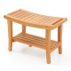 Teak shower stool showcasing a sturdy design, ergonomic curved seat, and convenient lower shelf for bathroom essentials.