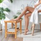 Teak shower stool with slatted top and storage shelf, featuring non-slip footpads for stability and comfort.