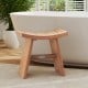 Teak wood shower bench with curved seat, 18 inches, ideal for bathroom use, featuring sturdy legs and drainage gap.