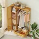 Bamboo clothing rack with cabinet, drawers, and hanging rod for organized storage in a natural finish.