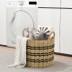 Woven round seagrass basket with handles, featuring a durable design for stylish storage and organization in any room.